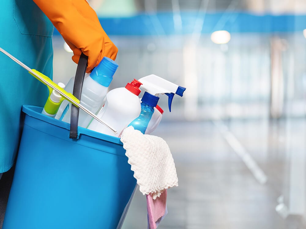 Residential Cleaning Dusting Shelves Holding Bucket Full Of Products